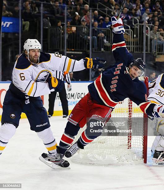 Mike Weber of the Buffalo Sabres hits Darroll Powe of the New York Rangers during the second period at Madison Square Garden on March 3, 2013 in New...