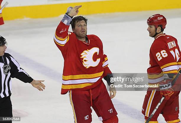 Brian McGrattan of the Calgary Flames salutes the fans after fighting Tom Sestito of the Vancouver Canucks during their NHL game at the Scotiabank...