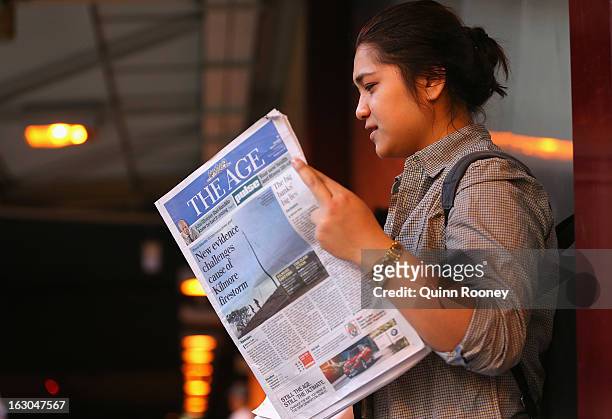 Commuter reads The Age's first compact edition newspaper at Flinders Street Station on March 4, 2013 in Melbourne, Australia. The Sydney Morning...