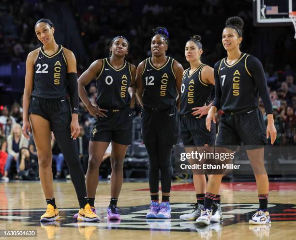 Ja Wilson, Jackie Young, Chelsea Gray, Kelsey Plum and Alysha Clark of the Las Vegas Aces look on as the Los Angeles Sparks shoot free throws after...