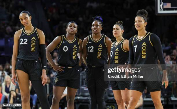 Ja Wilson, Jackie Young, Chelsea Gray, Kelsey Plum and Alysha Clark of the Las Vegas Aces look on as the Los Angeles Sparks shoot free throws after...