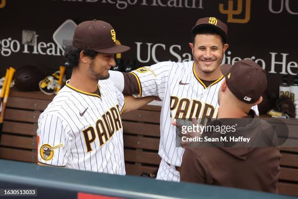 Yu Darvish talks with Manny Machado and Nick Martinez of the San Diego Padres after he was presented with a game ball by the Padres for being the...