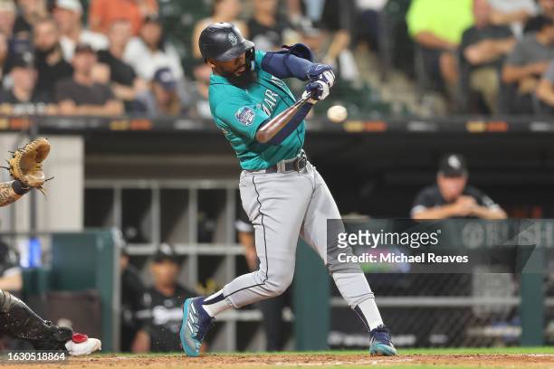 Teoscar Hernandez of the Seattle Mariners hits a two-run single against the Chicago White Sox during the sixth inning at Guaranteed Rate Field on...
