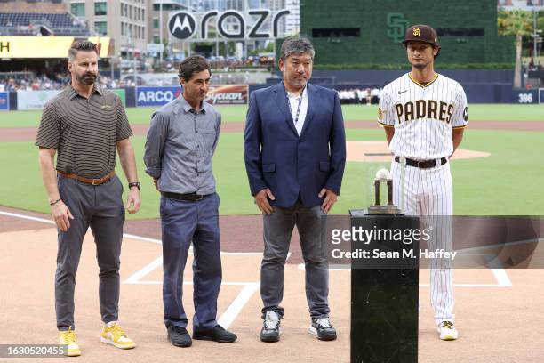 Erik Greupner , General Manager A.J. Preller, and retired MLB pitcher Hideo Nomo present Yu Darvish of the San Diego Padres with a game ball by the...