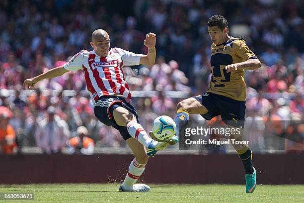 Robin Ramirez of Pumas, fights for the ball with Jorge Enriquez of Chivas during a match between Pumas and Chivas as part of the Clausura 2013 at...