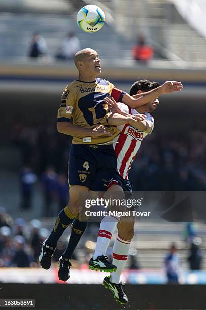 Dario Veron of Pumas fights for the ball with Rafael Marquez of Chivas during a match between Pumas and Chivas as part of the Clausura 2013 at...