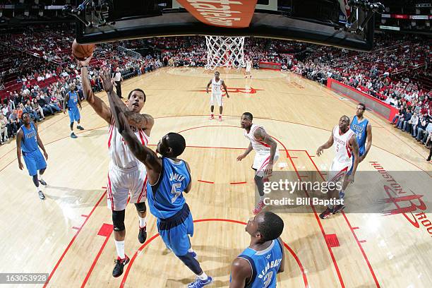 Greg Smith of the Houston Rockets shoots the ball against Bernard James of the Dallas Mavericks on March 3, 2013 at the Toyota Center in Houston,...