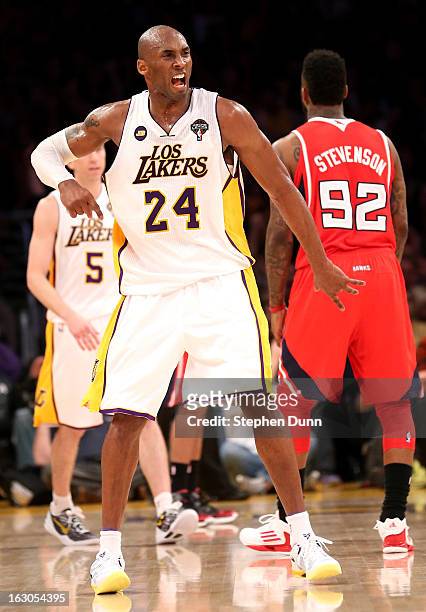 Kobe Bryant of the Los Angeles Lakers celebrates after making a three point basket at the buzzer ending the third period against the Atlanta Hawks at...