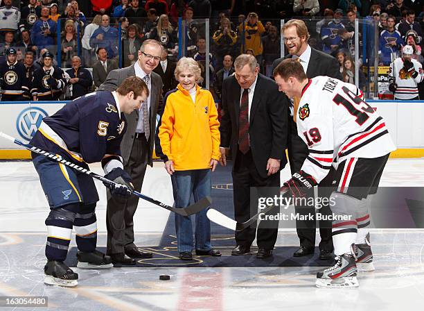 Barret Jackman of the St. Louis Blues is joined by former Blues defensemen Al MacInnis, Helen Plager, wife of former Blues great Barclay Plager,...