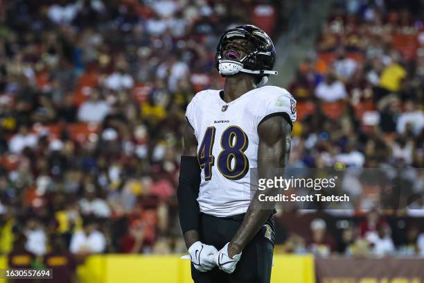 Jeremiah Moon of the Baltimore Ravens celebrates after recording a sack against Sam Howell of the Washington Commanders during the first half of the...