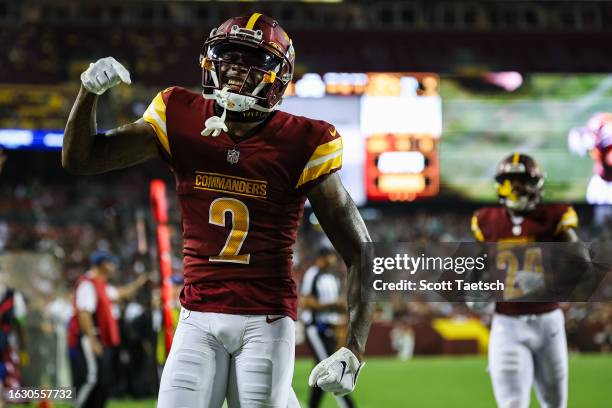 Dyami Brown of the Washington Commanders celebrates after a touchdown against the Baltimore Ravens during the first half of the preseason game at...