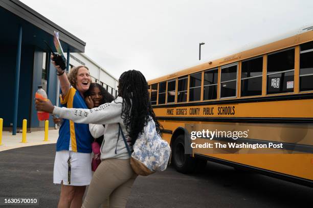 Hyattsville, MD School buses pull up with children heading to their first day at the new Hyattsville Middle School. Specialist, Anne Jarmon, left,...