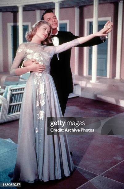 Grace Kelly dances with Frank Sinatra in a scene from the film 'High Society', 1956.