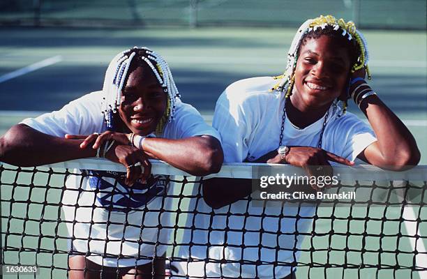 Teenage tennis sisters from America, Venus and Serena Williams take time off a practise session to pose together during the Adidas International...