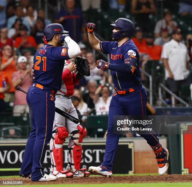 Chas McCormick of the Houston Astros celebrates his solo home run with Yainer Diaz in the eighth inning against the Boston Red Sox at Minute Maid...