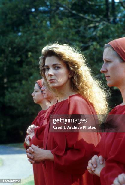 Natasha Richardson walks with two other women in a scene from the film 'The Handmaid's Tale', 1990.