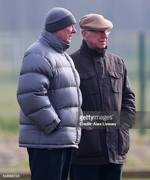 Sir Alex Ferguson the manager of Manchester United talks with Sir Bobby Charlton during a training session at Carrington Training Ground on March 4,...
