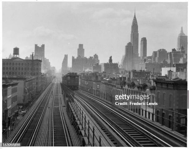 Elevated railway in transit with the New York Skyline in the background in New York City, New York, 1955.