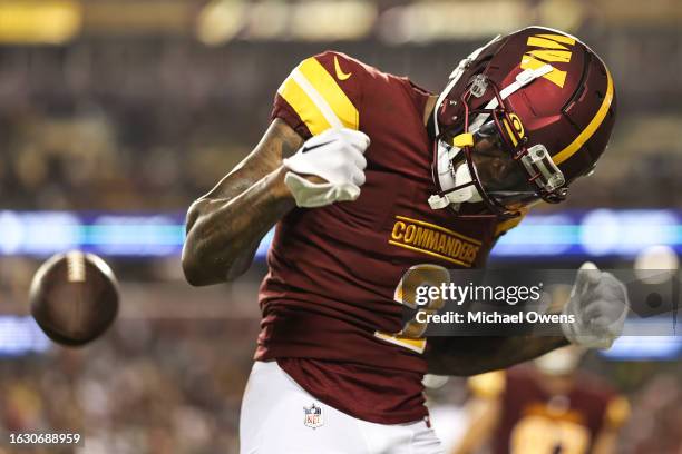 Dyami Brown of the Washington Commanders celebrates after completing a pass for a touchdown against the Baltimore Ravens during an NFL preseason game...