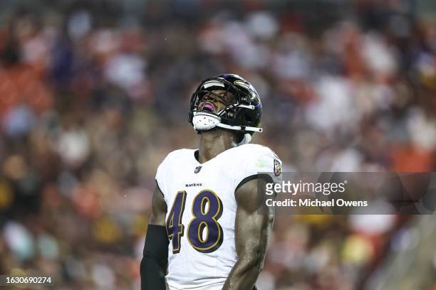 Jeremiah Moon of the Baltimore Ravens reacts after making a tackle against the Washington Commanders during an NFL preseason game at FedExField on...