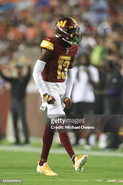 Emmanuel Forbes of the Washington Commanders reacts after making a stop against the Baltimore Ravens during an NFL preseason game at FedExField on...