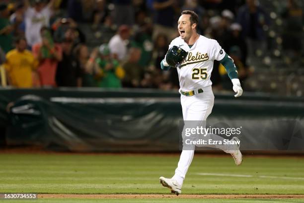 Brent Rooker of the Oakland Athletics rounds the bases after he hit a two-run home run in the ninth inning to beat the Kansas City Royals 6-4 at...