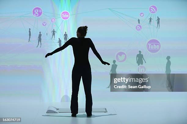 Performer practices her steps at the IBM stand at the 2013 CeBIT technology trade fair the day before the fair opens to visitors on March 4, 2013 in...