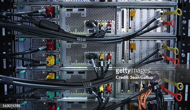 Cables lead to the components of an IBM XIV Storage Sytem at the IBM stand at the 2013 CeBIT technology trade fair the day before the fair opens to...