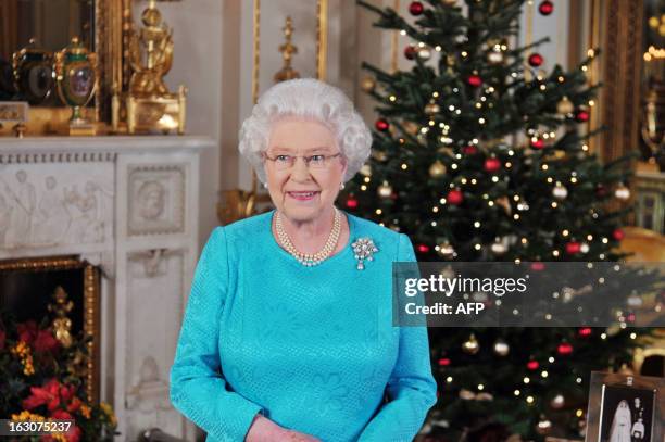 Queen Elizabeth II poses on december 23, 2009 prior recording her Christmas Day broadcast to the Commonwealth, in the White Drawing Room at...