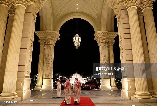 Saudi men walk out of the entrance to the Ritz-Carlton Hotel, where U.S. Secretary of State John Kerry is staying in Riyadh on March 4, 2013. From...