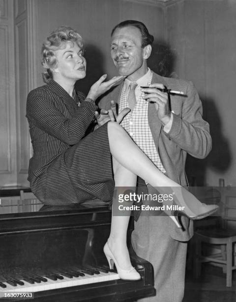 French singer and actress Line Renaud with English comic actor Terry-Thomas at rehearsals for the BBC TV show 'Around The Town', London, 30th...