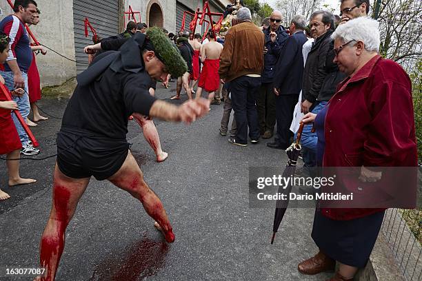 Vattiente beats his legs with a Cardo, a piece of cork containing 13 small pieces of glass, during the procession of the Madonna Addolorata in Nocera...
