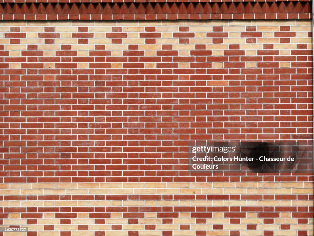 Close-up of a beige and brown brick wall with a geometric design in Geneva, Switzerland