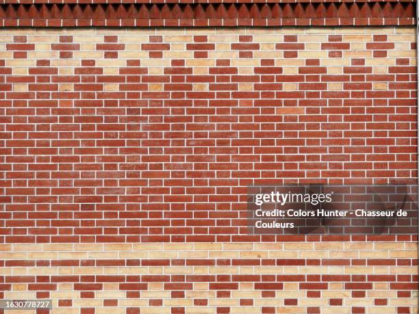 close-up of a beige and brown brick wall with a geometric design in geneva, switzerland - newly industrialized country stock pictures, royalty-free photos & images