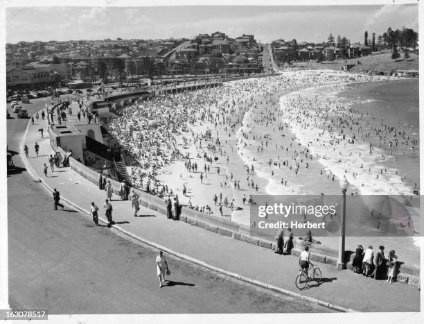 Thousands of people flocked to the wide sand, shelving beach and good ocean surfing, Coogee Beach, seen in this photograph, is one of the popular of...