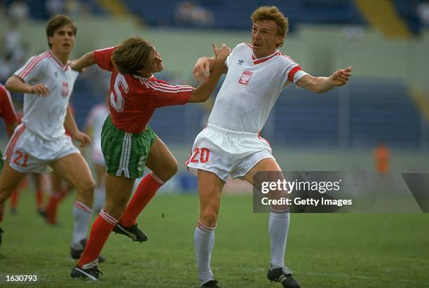 Alvaro of Portugal tangles with Zbigniew Boniek of Poland during the World Cup match at the Universitario Stadium in Monterrey, Mexico. Poland won...