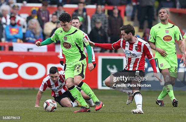 Lewis Hornby of Northampton Town looks to control the ball watched by Matt Oakley of Exeter City during the npower League Two match between Exeter...