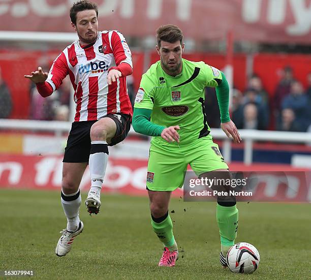 Ben Harding of Northampton Town looks to play the ball under pressure from Matt Oakley of Exeter City during the npower League Two match between...