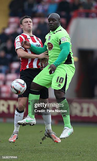 Adebayo Akinfenwa of Northampton Town attempts to control the ball under pressure from Danny Coles of Exeter City during the npower League Two match...