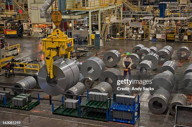 coiled steel is moved in a warehouse - plants indoors stock pictures, royalty-free photos & images