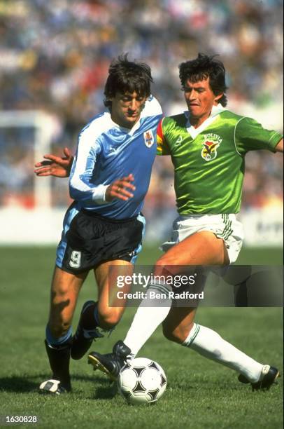 Enzo Francescoli of Uruguay is tackled during the World Cup qualifying match against Bolivia in Uruguay. Uruguay won the match 2-0. \ Mandatory...