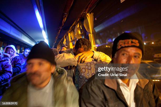 Palestinians on board a bus as a new line is made available by Israel to take Palestinian labourers from the Israeli army crossing of Eyal, near the...