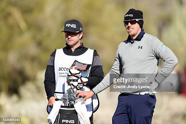 Hunter Mahan and his caddie John Wood look on during the final round of the World Golf Championships - Accenture Match Play at the Golf Club at Dove...