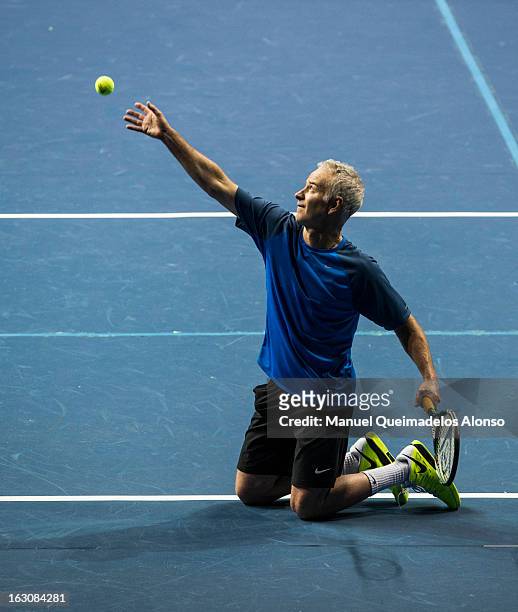 John McEnroe serves on his knees during his match against Ivan Lendl as part of the Hong Kong Showdown at the Asia-World Expo on March 4, 2013 in...