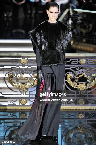 Model walks the runway during the John Galliano Fall/Winter 2013 Ready-to-Wear show as part of Paris Fashion Week at Le Centorial on March 3, 2013 in...