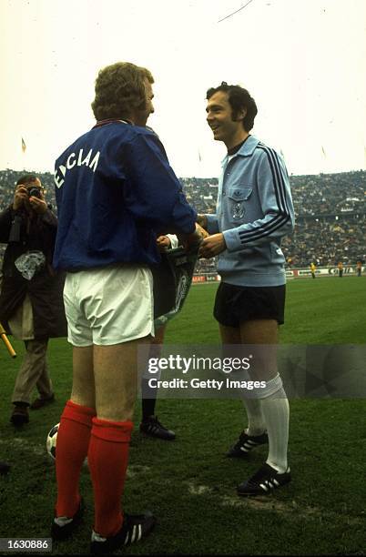 England Captain Bobby Moore chats with West German Captain Franz Beckenbauer before the European Championship qualifying match in Berlin. The match...