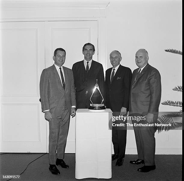 Pontiac GTO - Car OF The Year Award Luncheon. From left, Robert E. Petersen, John DeLorean, Walt Woron, pose with the iconic calipers trophy.