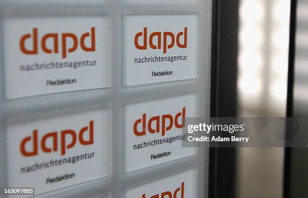 Company logos are seen in the elevators of the offices of the German news agency dapd on March 4, 2013 in Berlin, Germany. The country's...