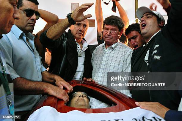 Fans of Paraguay's Olimpia football club pay their last respects to legendary Uruguayan footballer and coach Luis Cubilla, during his wake at the...