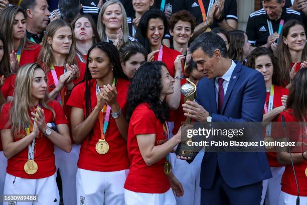 Spanish Prime Minister Pedro Sanchez holds the trophy as he meets the Spanish women’s national football team at Moncloa Palace after they won the...